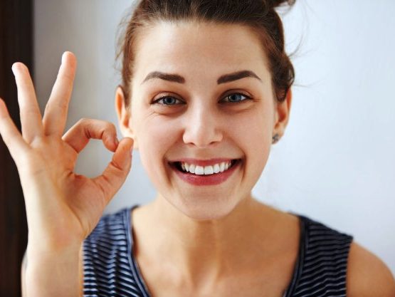 happy woman smiling after a visit to a dentist